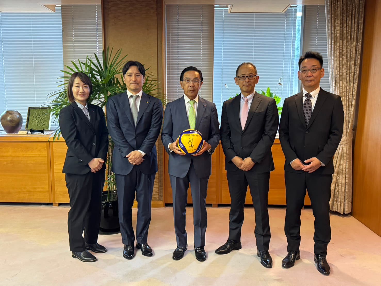 西脇隆俊知事（中央）とKYOTO VALLEY一行。知事にはサイン入りバレーボールをお受け取りいただきました。
